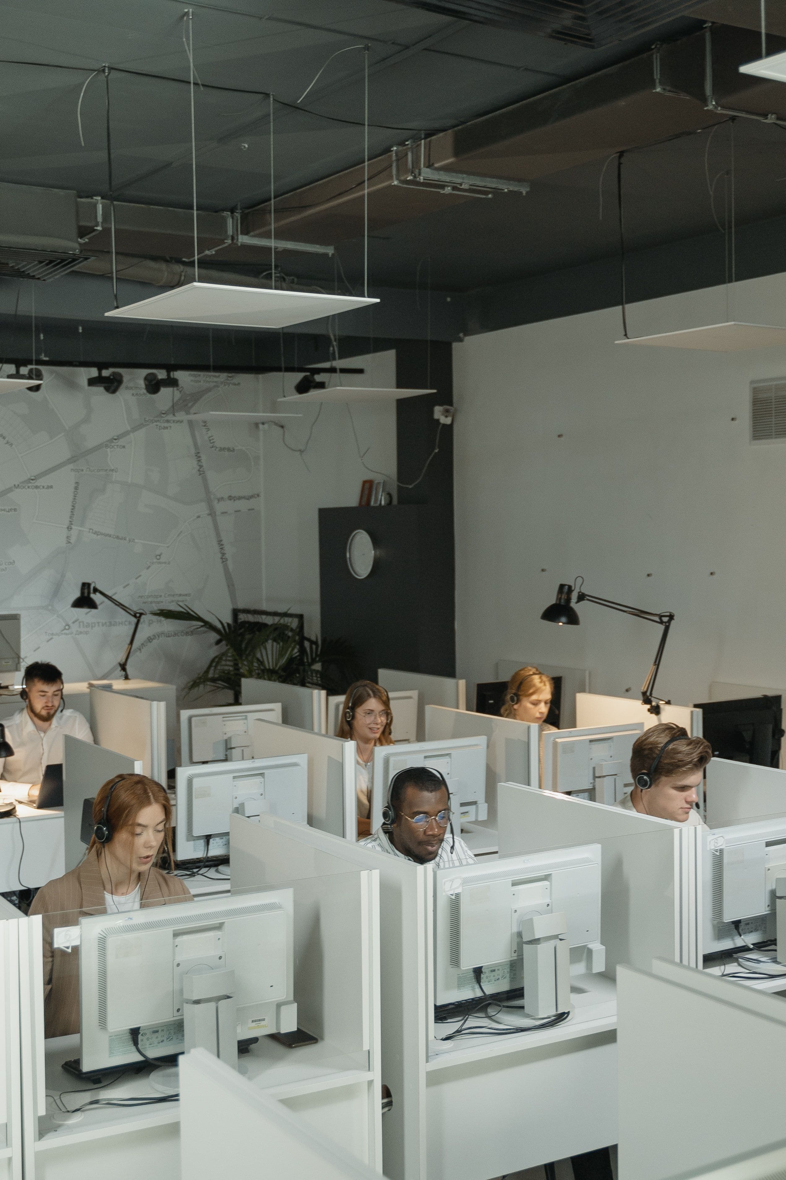Telecom operations team on headsets in a call center